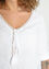 Lange, effen blouse in linnen met veelkleurig biesje, vlechtjes en pompons